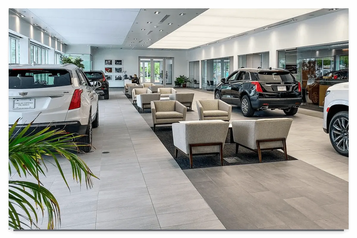 The interior of John Elway Dealerships building, with cars on the side and seats in the middle